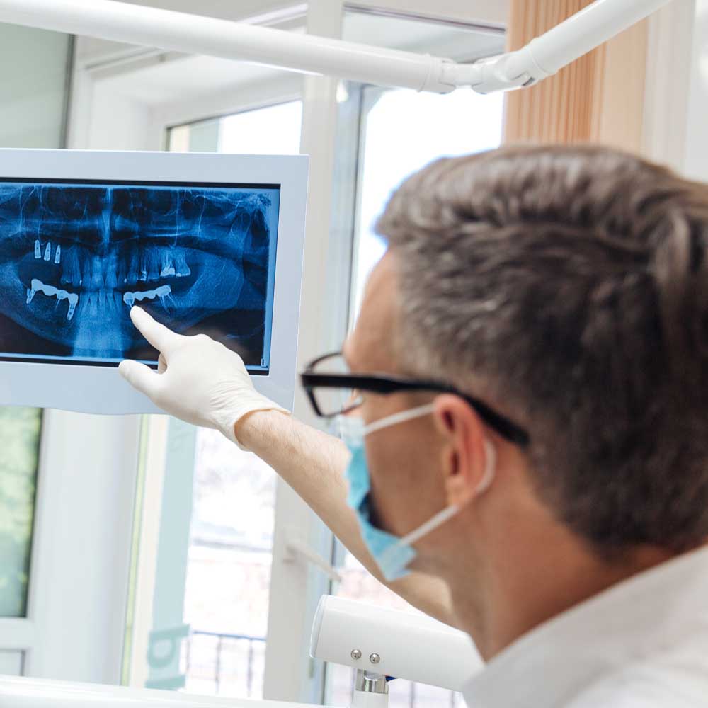 dentist looking at Digital X-Rays