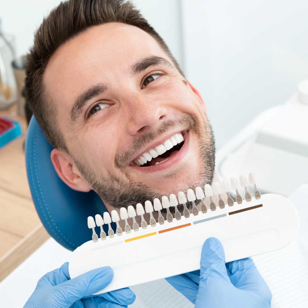 man choosing color of dental veneers